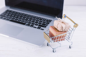 small grocery cart with gift boxes laptop